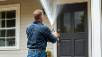 Man power washing a house for effective cleaning and maintenance.