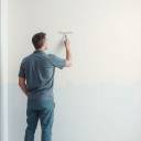 Man painting an interior room with vibrant colors for a fresh look.